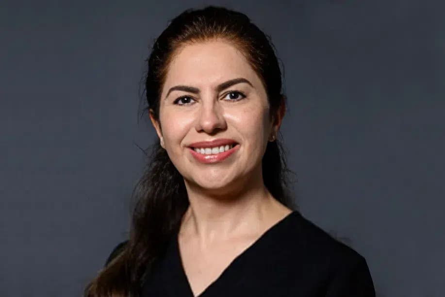 Suri, dental hygienist at Alpine Dental in Burke, VA, smiling in the office
