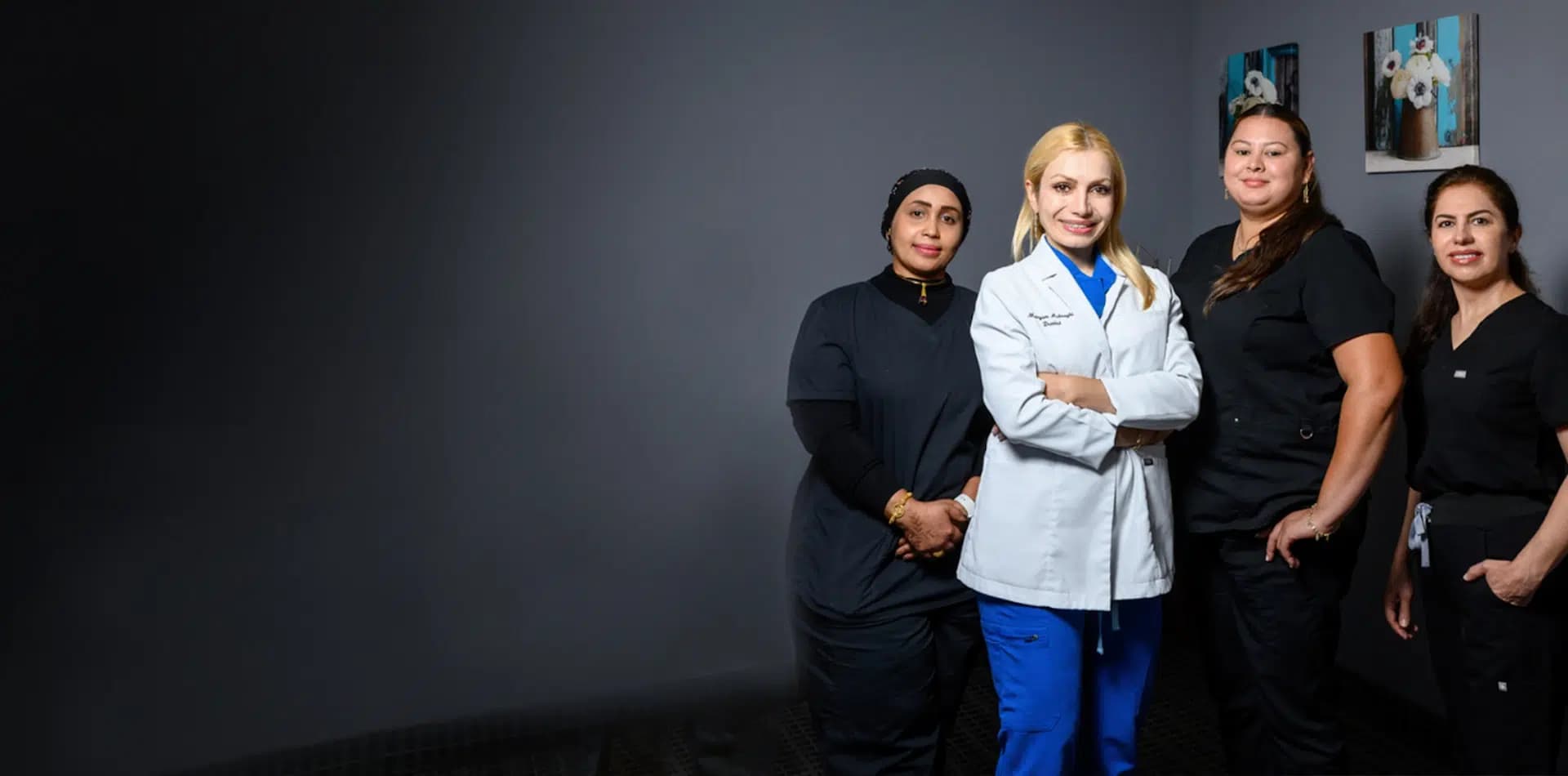 Dr. Maryam Ashraghi and the Alpine Dental team smiling inside their dental office in Burke, VA