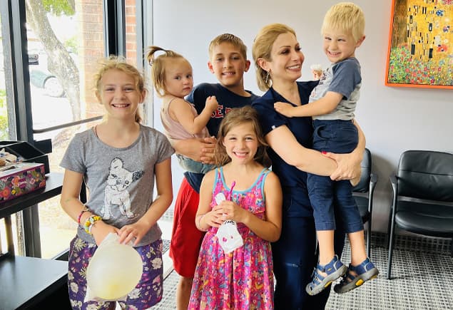 Alpine Dental team member with smiling children in the Burke, VA office for preventive dentistry